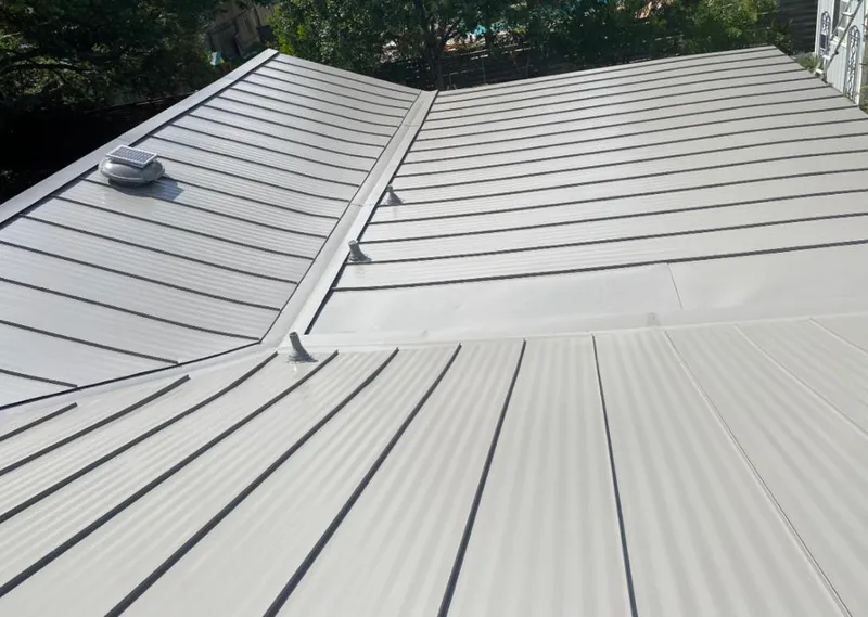 Solar attic fan installed on a metal roof for Roof Ventilation in New Prague